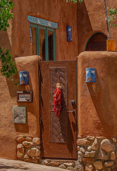 a door with a red scarf hanging on it's side in front of a building