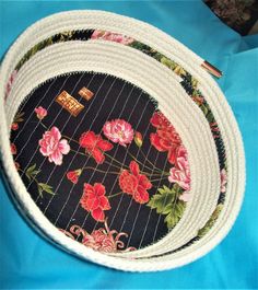 a black and white flowered placemat on a blue table cloth