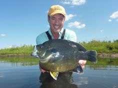 a man holding a large fish in the water