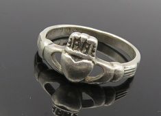 925 Sterling Silver - Vintage Petite Traditional Claddagh Band Ring Sz 6- RG9931  925 Sterling Silver - Vintage Petite Traditional Claddagh Band Ring Sz 6- RG9931  Jewelry Type:         Ring  Metal Type:            925 Silver  Metal Size:             6 Finger  Stone Type:            N/A  Condition:              N/A  Jewelry Weight:     2 Grams  PLEASE NOTE: THIS ITEM IS PRE-OWNED. ALTHOUGH MOST ITEMS ARE IN VERY GOOD CONDITION, SOME MAY NEED CLEANING AND/OR MINOR REPAIRS. WE MAKE A VERY STRONG EFFORT TO UPLOAD CLEAR PICTURES. PLEASE INSPECT ALL PICTURES AND ASK ALL QUESTIONS YOU MAY HAVE PRIOR TO MAKING A PURCHASE. NOT ALL STONES ARE GENUINE, SOME ARE ENHANCED OR CREATED. Silver Claddagh Ring, Irish Ring Claddagh, Irish Rings, Celtic Knot Designs, Unique Bands, Claddagh Rings, Ring Metal, Sterling Ring, Silver Band