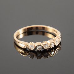 a gold ring with three diamonds on it