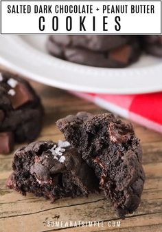 chocolate cookies with sea salt on top and one broken in half sitting on a wooden table