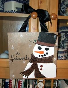 a wooden sign with a snowman on it