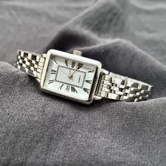 Woman Wrist Watch, Silver Colour Watch, Roman Numeral Dial, Rectangle Design Watch, Modern Design Watch, Adjustable Band, White Dail, Gift for Her, Mother's Day Gift, Valentine's Day Gift, Present for Her, Daily Usage, Christmas Gift Diamensions: - Case Thickness: 9 mm - Case Diameter: 25 mm x 20 mm - Band Width: 12 mm - Weight: 50 gr Classic Square Watch Accessories For Gifts, Classic Silver Rectangular Watch Accessories, Timeless Rectangular Stainless Steel Watch Accessories, Timeless Stainless Steel Rectangular Watch Accessories, Square Watch With Metal Dial For Gift, Silver Rectangular Watch Accessories For Gifts, Silver Rectangular Watch Accessories As Gift, Rectangular Silver Watch Accessories For Gifts, Rectangular Stainless Steel Watch Accessories For Gifts