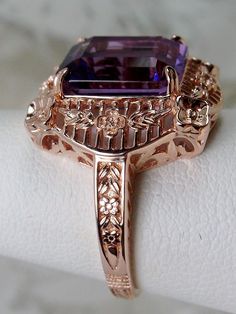 Natural Purple Amethyst Rose Gold plated Sterling Silver RingPicture Frame Design#D227 Inspired by Victorian era designs, this is a lovely reproduction ring. This lovely filigree handcrafted sterling silver ring is overlaid with rose gold plating. This flawless 5 carat Natural Purple Amethyst is 11mm x 9mm. The ring is 11/16" (17.5mm) North to South on the finger. The inside of the band is marked 925 for sterling silver. Notice the beautiful daisies on the outside of the setting and band. There Vintage Sterling Silver Rose Gold Rings, Heirloom Amethyst Rings With Intricate Design, Amethyst Rings With Intricate Design For Wedding, Victorian Amethyst Jewelry For Weddings, Victorian Amethyst Wedding Jewelry, Elegant Purple Amethyst Ring With Intricate Design, Heirloom Amethyst Ring For Anniversary With Intricate Design, Fine Jewelry Amethyst Ring With Filigree For Formal Occasions, Formal Fine Jewelry Amethyst Ring With Filigree