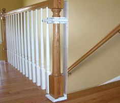 a wooden banister sitting on top of a hard wood floor