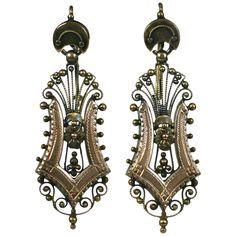 Elaborate filigreed Victorian 14k gold earrings from the late 19th Century. Rose gold applications in harp form are framed by etruscan bead work and florets. Yellow gold has been left with original patina. Can be polished to high finish if needed. 1880's USA. Excellent condition. 1 5/8" x .5". Antique Earrings With Historical Design For Ceremonial Occasions, Antique Drop Earrings With Historical Design, Antique Gold Earrings With Historical Design, Antique Brass Chandelier Earrings, Antique Filigree Chandelier Earrings For Formal Occasions, Victorian Engraved Earrings For Formal Occasions, Ornate Chandelier Earrings For Formal Occasions, Ornate Filigree Chandelier Earrings For Formal Occasions, Victorian Yellow Gold Earrings With Intricate Design