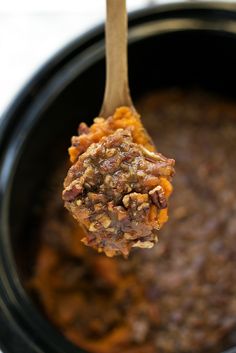 a spoon full of food in a crock pot