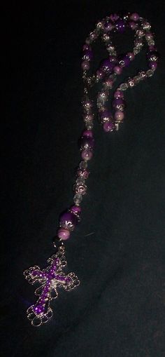 Cross is 2 in long 1 1/2 in wide  Purple  Necklace is -19 in long beads-8mm Mix colors purple glass-2mm , Clear beads 2 mm, Silver flower caps , Center piece Purple Cross Necklace, Purple Beaded Chain Bracelet With Round Beads, Purple Beaded Chain Bracelets With Round Beads, Bohemian Purple Polished Beads, Purple Beaded Necklaces With Round Beads, Spiritual Purple Beaded Necklaces With Colorful Beads, Purple Czech Glass Beaded Necklace For Gift, Spiritual Purple Beaded Necklace With Colorful Beads, Purple Faceted Round Beads