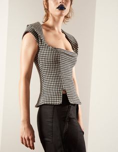 Made in the UK.This top is created by independent London-based fashion label Lula Laora. This garment was designed as part of our AW21 collection 'Simple Pleasures'; the concept of this collection is to allow the wearer to embrace and share their natural desires. The collection mixes masculine and feminine silhouettes and cuts.Mademoiselle top in hounds tooth. Fitted top with plunging square neckline and wide reverse Peter Pan collar. Features capped sleeves, waist darts and hem slits for a subt Fitted Padded Blouse Crop Top Casual, Fitted Padded Blouse Crop Top, Casual Style, Fitted Casual Crop Top With Padded Blouse, Structured Fitted Tops For Fall, Fitted Structured Tops For Fall, Modern Fitted Cropped Blouse, Fitted Cropped Padded Top, Trendy Crop Top For Workwear, Trendy Crop Top For Work