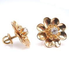 "These charming vintage earrings, in the shape of a daisy, are made of 14K yellow gold and have a diamond prong set in their center. Perfect for \"setting and forgetting,\" these earrings are secured with a screw back, meaning you'll never have to worry about one of them falling out! DETAILS METAL: 14K Yellow Gold DIAMONDS: 2x European Cut diamonds (0.40tcw) WIDTH: 17mm" 14k Yellow Gold Flower Earrings For Anniversary, Gold Flower Earrings With Brilliant Cut, Yellow Gold Flower Earrings With Prong Setting, Formal Flower Shaped Diamond Earrings In 14k Gold, Yellow Gold Flower Cluster Earrings For Anniversary, Yellow Gold Flower Earrings With Brilliant Cut, Formal 14k Gold Diamond Earrings With Flower Shape, Yellow Gold Flower Diamond Earrings With Brilliant Cut, Formal 14k Gold Flower-shaped Diamond Earrings