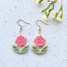 pink and green flower earrings with leaves on them