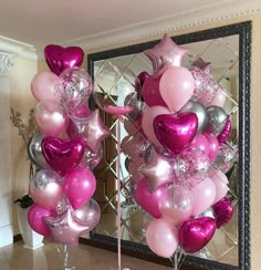 pink and silver balloons in front of a mirror