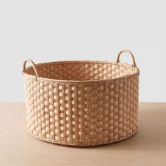 a woven basket sitting on top of a wooden table