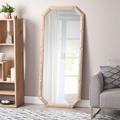 a living room with a couch and a large mirror