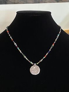 "Minimalistic beads with quarter-sized coin pendant sending a message of love, faith, peace and spirit. Beads are in southwestern colors and the tiny size offers a minimal boho look that can be on it's own our easily layered. The perfect Urban Boho style. Necklace length is 18\". Bead mix: Ancient (over 2,000 yrs. old) Djenne beads, African trade beads, and Roman glass beads. Other beads include, Labradorite, faceted hematite, genuine turquoise, Venetian glass, and TOHO seed beads. Free gift of Handmade Bohemian Disc Jewelry, Handmade Bohemian Round Disc Jewelry, Bohemian Handmade Round Disc Jewelry, Medallion Necklace With Coin Pendant For Festivals, Festival Medallion Necklace With Coin Pendant, Festival Coin Pendant Medallion Necklace, Festival Coin Pendant Necklace In Medallion Shape, Handmade Coin Medallion Necklace In Bohemian Style, Handmade Bohemian Coin Medallion Necklace