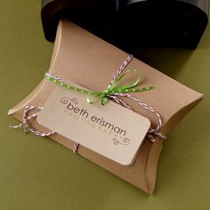 a brown package with a green ribbon tied around it