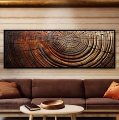 a living room scene with focus on the couch and wooden wall art hanging above it