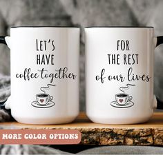 two coffee mugs sitting on top of a wooden table with the words, let's have together of our lives