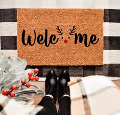 someone is sitting on the floor with their feet propped up in front of a welcome mat