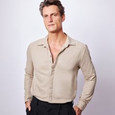 A soft, long-sleeve black shirt with a wide collar and hidden buttons. The organic viscose fabric is breathable and drapes perfectly over the body. Shirts are the must-have wardrobe staple for everyone.  Try pairing this shirt with slim trousers and a pair of smart shoes for a stylish and refined look. Or pair this shirt with black jeans and sneakers for a casual outfit. ✔️ The perfect garment that can easily be styled with most garments.  ✔️ The versatility of this shirt allows for endless amounts of outfit ideas.  ✔️ This Long Sleeve Shirt is ideal for your daily/casual use or gift for your loved ones, your Father, Son, Boyfriend, Husband, Darling. ✔️ Shirt is Perfect Gift for Birthday, Anniversary, New year, Father's Day, Valentines Day. ✔️ Dress it up or down, the choice is yours. DETA Semi-formal Tops With Fold Down Collar, Versatile Collared Formal Tops, Casual Slim Fit Top With Lapel Collar, Versatile Collared Business Casual Top, Slim Fit Tops With Fold Down Collar For Fall, Versatile Collared Top For Business Casual, Versatile Fitted Long Sleeve Shirt, Versatile Long Sleeve Fitted Shirt, Versatile Long Sleeve Formal Tops