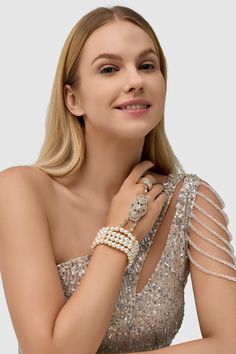 This sumptuous piece of jewelry features a retro-elegant yet slightly modern style that complements the lavish garments, reminiscent of the roaring 1920s. Features: High quality Austrian crystals and imitation pearls Four strand design Inner perimeter of bracelet is 7.4"/ 18.8cm Diameter of ring: 0.7"/ 1.78cm Elegant Pearl Bracelet For Party, Glamorous Jeweled Bracelets For Party, Party Pearl White Beaded Bracelets With Pearl Chain, Party Pearl White Beaded Bracelets, Glamorous Pearl Jewelry For Formal Occasions, Party Pearl Bracelets With Pearl Chain, Elegant Beaded Bling Bracelets For Party, Elegant Pearl Bracelets For Party, Evening Pearl Bracelet Jewelry