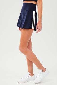 Side view of girl wearing dark blue upper thigh skirt with built in shorts, with two white stripes down the side and white shoes Stripe Fashion, Keds Style, Pickleball Court, Tennis Skirts, Spin Class, Tennis Skirt, Side Stripe, Wide Waistband, Super Powers