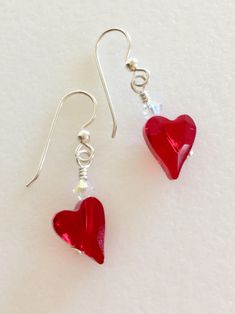 "Adorable little Valentine red Swarovski Crystal heart earrings. Elongated 12 x 10 x 6 mm Siam red Swarovski hearts are wire wrapped in Sterling silver with tiny 4 mm clear Swarovski crystals AB. Crystals hang from Sterling silver French ear hooks with ball decor. They measure 1 3/8\" long and are very lightweight. Perfect sweetheart earring with that pop of red!" Red Sterling Silver Dangle Heart Earrings, Red Heart Charm Earrings For Anniversary, Red Heart Beads Earrings For Valentine's Day, Red Double Heart Earrings With Heart Beads, Red Heart Earrings For Valentine's Day Wedding, Handmade Red Heart Sterling Silver Earrings, Handmade Red Heart Earrings In Sterling Silver, Red Heart Earrings For Wedding, Red Heart Beads Earrings For Gift