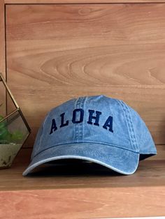 Add some tropical flair to your outfit with our Aloha baseball hat! Perfect for sunny days at the beach or just adding a pop of color to your look. Keep cool and stylish with this playful hat. (No one will be able to resist saying "aloha" to this hat!) Swimwear Store, Beach Beauty, Swim Shop, One Piece Swim, Hats For Sale, Accessories Branding, Scarf Hairstyles, Shoe Sale, Sunny Days