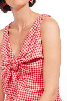 Take your summer barbeque to the next level with our pink gingham plaid Gidget Top. Featuring an oversized bow detail and a V-neckline, this top is perfect to wear with your favorite jeans for a relaxed, fun look. Oversized bow Pullover styling Sleeveless Hand wash Polyester, Rayon, Spandex Lining Polyester Dimensions23.5"L Summer Barbeque, School Wear, Bow Top, Plaid Bow, Pink Gingham, Brand Collection, Jacket Brands, Bow Detail, Favorite Jeans