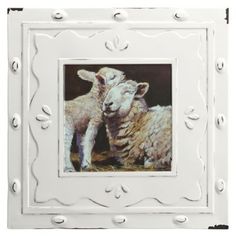 two sheep standing next to each other in a white frame