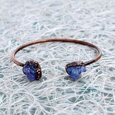 GemFormingStudio D E T A I L S Tanzanite Bangle | Adjustable Bangle | Bangle For Her | Bangle For Women | Gift For Her | Gift For Women | Gemstone Bangle [GFS2855] Stone Size: 12x11 mm Weight: 10.86 gm Bangle Size: 3 inches Color: purple Material: Copper Polish: Copper Antique Plated . Contact us for wholesale prices. R I N G S https://www.etsy.com/in-en/shop/GemFormingStudio?section_id=22783374 B E A D S https://www.etsy.com/in-en/shop/GemFormingStudio?section_id=22828835 W A N D S https://www. Gemstone Bangle Bracelets, How To Polish Copper, Adjustable Bangle Bracelet, Gemstone Bangle, Antique Bracelets, Antique Plates, Tanzanite Gemstone, Blue Tanzanite, Adjustable Bangle