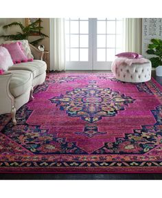 a living room with pink rugs and furniture