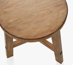 a round wooden table with two legs and a small circular wood table on one end