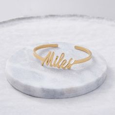 Turn any unique handwriting into a bold cuff. Use a child’s name, loved one’s signature, word from a special letter, or new last name to create a bold everyday cuff to wear on its own or layered with other favorite bracelets. Remember that you can always choose our default signature font and customize with any word or name. 14k solid gold customers will be sent a design proof for approval before moving into production. /!/ Size: One size, adjustable, band width is 3mm wide Available in sterling Modern Customizable Name Bracelet, Modern Adjustable Bracelets With Custom Name, Modern Custom Name Bracelet For Gift, Signature Personalized Bracelets For Anniversary, Modern Customizable Bracelets For Personalized Gifts, Modern Custom Name Bracelet For Personalized Gift, Modern Personalized Bangle As Gift, Personalized Signature Bracelets For Anniversary, Custom Name Bangle Cuff Bracelet For Anniversary