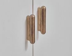 two pieces of wood are hanging on the wall