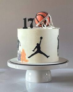 a birthday cake decorated with basketballs and the number one on it's side