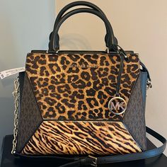 Crafted With Blend Of Animal-Print Calf Hair, Leather And Logo Print, The Prism Satchel Will Lend Geometric Edge To The Season’s Luxe Looks. The Compact Design Unzips To Reveal An Interior That’s Roomy Enough To Store Everyday Essentials. Wear It As A Crossbody Bag Or Carry It By The Top Handles. Top-Handle Bag Printed Calf Hair/Leather/Logo-Print Canvas 100% Leather Trim 1: 100% Calf Hair Gold Tone Hardware 12"W X 10"H X 5"D Handle Drop: 4.25" Exterior Details: Front Snap Pocket Interior Detail Leopard Print Handbags, Animal Print Handbags, Bags Michael Kors, Exterior Details, Michael Kors Purse, Purses Michael Kors, Leather Logo, Calf Hair, Printed Bags