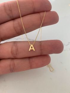 "Minimalist 14K Gold Initial Necklace, Solid Gold Initial, Gold Choker, Dainty Initial, Choker, Dainty Gold Chain, Initial Necklace 14K Gold This dainty initial necklace is a beautiful, affordable dainty piece of jewelry that is great for everyday wear. It comes available in any gold color: rose gold, yellow gold or white gold. This necklace can be used in combination any of our other necklaces for a layering effect. A great idea for Valentine's Day, Mother's Day, Birthday, Anniversaries and Christmas. ♦ Materials: 14K Yellow Gold, 14K White Gold, or 14K Rose Gold ♦ Available colors: White Gold, Rose Gold, Yellow Gold ♦ Necklace measurements: 14\"-22\" inches ♦ Initial Measurement: 6.5MM height ♦ Please advise if you would like an extender: This will be an additional fee of $25 ♦ These are Necklace With A Letter, Gold A Necklace, A Initial Necklace, Elegant Gold Initial Necklace, Adjustable, 14k Gold Initial Pendant Necklace - Gift For Her, Elegant Gold-tone Initial Pendant Chain Necklace, Gold Letter-shaped Minimalist Name Necklace, Letter Necklace Initials, Elegant Letter-shaped Initial Necklace