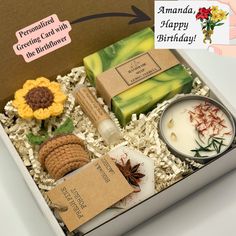 an open box containing soaps, candles and other personal care items for someone's birthday