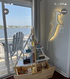 a child's room with a toy boat and bookshelf on the floor