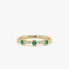 Become the timeless beauty everyone will remember. Emeralds are named after the Greek word for "green," and it is the birthstone of May, the season of spring and rebirth. This ring embodies an era of unmatched glamour and sophistication. Available in Yellow Gold, White Gold, and Rose Gold.  - Handmade - Solid Gold - Natural Diamonds and Emerald  - G Color, SI Quality Diamonds - Total Diamond Carat Weight: 0.09 ctw - Total Emerald Carat Weight: 0.20 ctw - Band Thickness: 1.5 mm - Ring Width: 2.8 Elegant Green Stackable Rings With Bezel Setting, Green Diamond Stackable Ring, Green Diamond Stackable Ring With Round Cut, Green Stackable Diamond Ring With Round Cut, Formal Green Half Eternity Jewelry, Green Diamond Stackable Ring For Formal Events, Fine Jewelry Bezel Set Ring With May Birthstone, Fine Jewelry Bezel Setting Ring For May Birthstone, Classic Green Diamond Stackable Ring