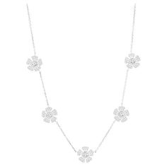 Diamond necklace set in 18K white gold. The necklace is set with 5 sections of baguette and round stones to create the illusion of a flower look. The total diamond weight of the piece is 2.62 carats. The color of the stones are F, the clarity is VVS1-VVS2. The necklace is measured at 16 inches. Baguette Necklace, Diamond Necklace Set, A Flower, Necklace Set, Chains Necklace, Diamond Necklace, 50 %, Jewelry Necklaces, White Gold