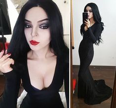 a woman with long black hair is taking a selfie in a mirror and wearing a black dress