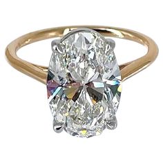 an oval cut diamond ring in yellow gold