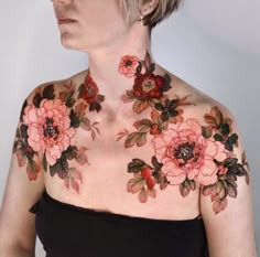 a woman with flowers on her chest wearing glasses