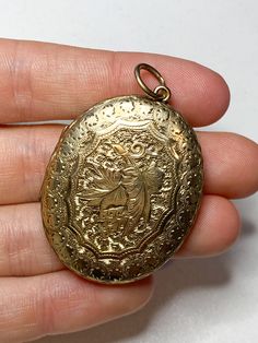 An amazing antique 9 karat gold locket. Featuring beautiful intricate floral scroll work on the front and back. You can put your desired photos inside the locket. The right side has a glass front inside. Not hallmarked but has been professionally tested for 9 karat gold at a jewellers. A beautiful locket pendant perfect to wear for any occasion Heavy weighing a total of 15.2 grams Measurements: The length is 4.2cm and the width is 3.2cm Condition: In really good antique condition. The fabric inside the locket on the left has been discoloured due to age. Please look at the photos as they are truly representative of the condition of this amazing locket All items are including postage tracked and signed for. Use the discount code MAGICJEWELS20 to receive €20 discount when purchasing two items Victorian Filigree Locket Necklace In Yellow Gold, Victorian Yellow Gold Locket Necklace With Filigree, Victorian Filigree Yellow Gold Locket Necklace, Ornate Gold Round Locket Necklace, Gold Etched Victorian Locket Necklace, Ornate Yellow Gold Medallion Locket Necklace, Victorian Filigree Locket Necklace For Anniversary, Antique Yellow Gold Locket Necklace For Wedding, Traditional Gold Medallion Locket Necklace