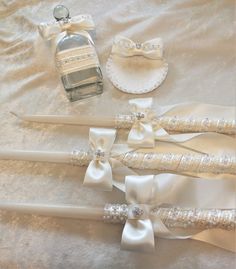 three wedding garters, one bottle of perfume and the other with pearls on them