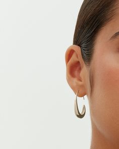 These exquisite pull-through teardrop earrings, measuring 24mm x 18mm with a 9mm opening, add an elegant touch to any look. Their distinctive shape and ideal size offer both style and comfort. Suited for any occasion, they enhance casual wear and elegantly complement dressy events, adding a touch of luxury at a great value. Materials 14K yellow gold or white gold plated. s925 Sterling Silver Posts. Measurements: Length: 24mm x 18mm; Opening: 9mm. Hypoallergenic; nickel, lead, and cadmium free. Modern Oval Teardrop Earrings For Pierced Ears, Sleek Metal Drop Earrings, Minimalist Formal Drop Earrings For Pierced Ears, Minimalist Formal Drop Earrings, Chic Teardrop Pierced Earrings, Elegant Silver Teardrop Wrap Earrings, Minimalist Teardrop Pierced Jewelry, Modern Hypoallergenic Teardrop Jewelry, Modern Drop Earrings With Ear Wire