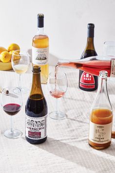 several bottles and glasses of wine on a table